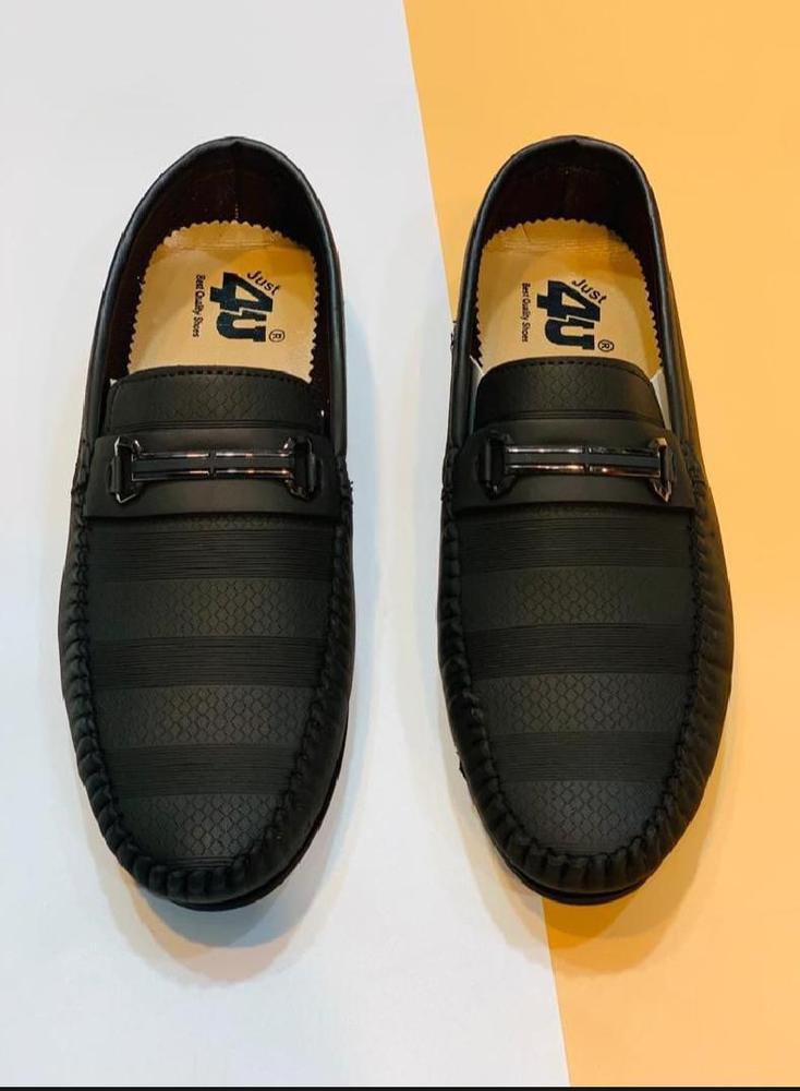 Top view of men's black loafers with textured design